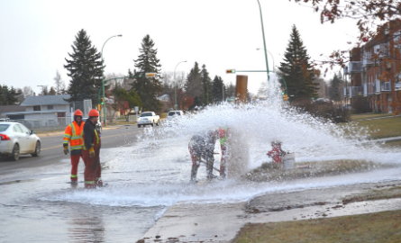City crews working on a bursting fire hydrant