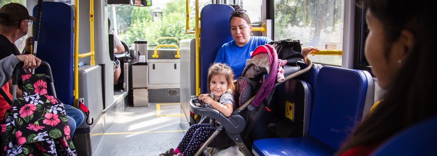 girl in a stroller on bus
