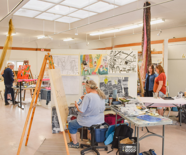 A group of artists working in the upstairs studio.