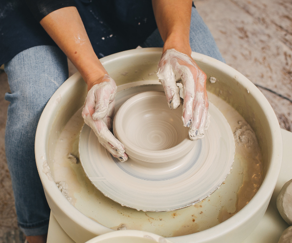 Potter throwing a vessel on the wheel